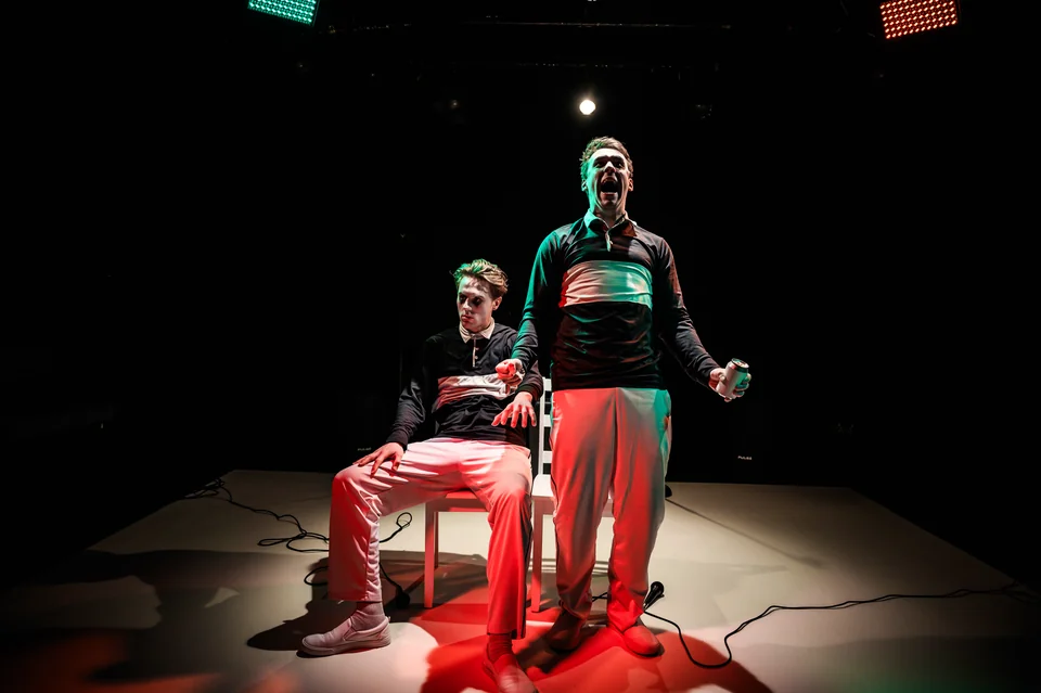 Nick Hyde and Oliver Maynard under red and green stage light in Double Act